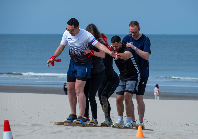 meerdere personen lopen samen op een plank